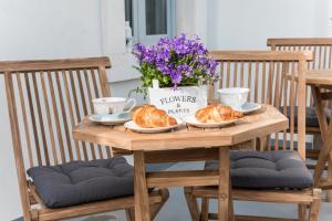 a wooden table with two croissants and flowers on it at Villa Galla in Split