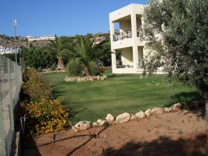 a large yard with a house and a yard sidx sidx sidx at Sifis Studios Pefkos in Pefki Rhodes