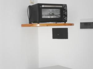 a small television sitting on a shelf on a wall at Appartamenti Da Nicola in Lampedusa