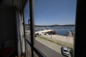 a view of a harbor from a window at Hotel As Brisas do Freixo in O Freixo