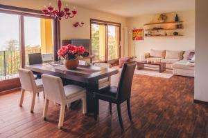 a living room with a dining room table and chairs at Villa Mimosa in Colico