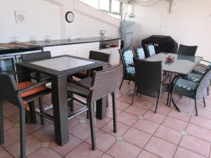 a dining room with two tables and chairs at 404 Ipanema Beach in Durban