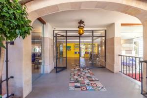 an entrance to a building with an archway and a hallway at Hotel Cala Sant Vicenç - Adults Only in Cala de Sant Vicenc