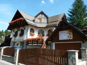 a house with a fence in front of it at Penzion Hakl in Harrachov