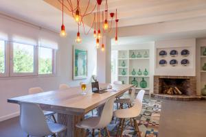 a dining room with a table and chairs and a fireplace at Hotel Cala Sant Vicenç - Adults Only in Cala de Sant Vicenc