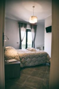 a bedroom with a bed and a window at Alba Magica in Agerola