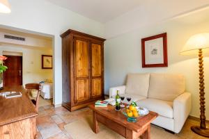 a living room with a couch and a table at Hotel Cala Sant Vicenç - Adults Only in Cala de Sant Vicenc