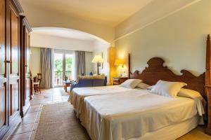 a bedroom with a large bed in a room at Hotel Cala Sant Vicenç - Adults Only in Cala de Sant Vicenc