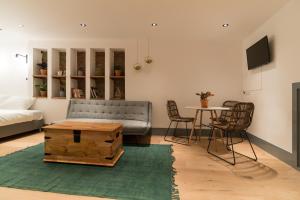 a living room with a couch and a table at Saint Claire Studio in Amsterdam