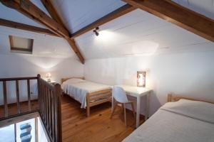 Postel nebo postele na pokoji v ubytování Auberge Lustincone