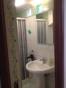 a bathroom with a sink and a mirror at Apartment Cara Sibilla in Marsala