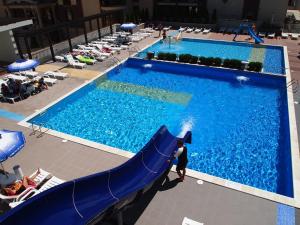 a large swimming pool with a blue slide in a hotel at Burgas Beach Hotel in Sunny Beach