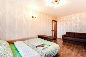 モスクワにあるFortEstate Volgina 25のベッド1台とソファが備わる小さな客室です。