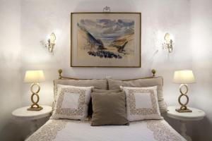 a bedroom with a bed with two night stands and two lamps at Alfa Luxury Villas in Chrissi Akti +208 photos
