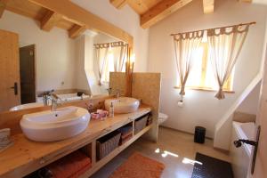 a bathroom with two sinks and a large mirror at Chalet Du Mont in Chateau-d'Oex