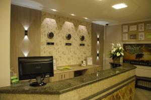 a reception desk with a computer on top of it at Hotel Majú in Rio Branco