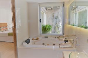 a bathroom with a bath tub and a window at CasaCalma Hotel in Buenos Aires