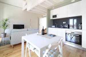 a kitchen and living room with a table and a couch at Msc Flats in Porto