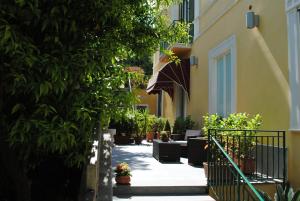 un cortile di un edificio con piante e ombrellone di Villa San Martino a Napoli