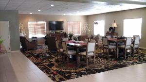 a dining room with a table and chairs on a rug at Sagebrush Hotel in Crystal City