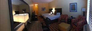 a hotel room with a bedroom with a bed and a couch at Sagebrush Hotel in Crystal City