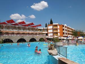 a group of people swimming in a swimming pool at Nessebar Beach Hotel in Sunny Beach
