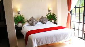 En eller flere senge i et værelse på Hotel Maya Turquesa