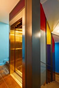 a elevator in a building with colorful walls at Hotel 54 Barceloneta in Barcelona