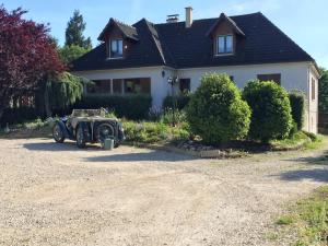 un coche viejo aparcado frente a una casa en Chambres D'hôtes du Plessis en Chailles