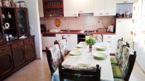 a kitchen with a table with chairs and a tableablish at Holiday home Gudelj in Imotski
