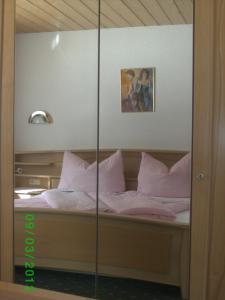 a bedroom with a bed with pink sheets and pillows at Apart Dorfblick in Kaunertal