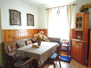 a dining room with a table with flowers on it at Chalupa Sněženka in Nýrsko