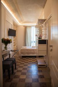a bedroom with a bed and a table and a desk at Petrosino in Palermo