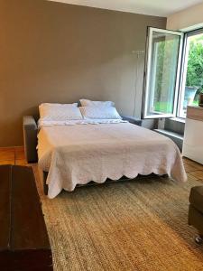 a bedroom with a bed and a large window at Casa Smile in Riva del Garda