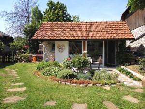 a cottage with a garden in front of it at Tiny house with a big heart in Postojna