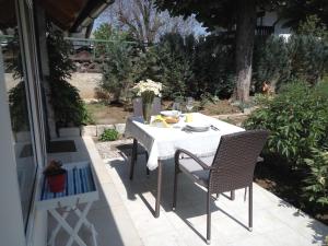 a white table and chairs on a patio at Tiny house with a big heart in Postojna