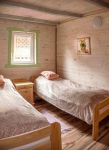 Posteľ alebo postele v izbe v ubytovaní Sosnowa Zagroda