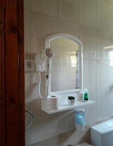 a bathroom with a blow dryer and a mirror at Sobe BCRNJAC in Međugorje