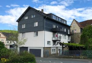 a large white house with a black roof at Ferienwohnung Janssen Herborn in Herborn