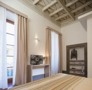 TV a/nebo společenská místnost v ubytování Antico Angelo - Residenza d'Epoca