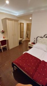 a bedroom with a large bed with a red blanket at Guest House Šterk in Nova Gorica