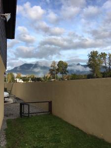 a fence with a view of mountains in the background at Casa Condominio Los Robles in Pucón