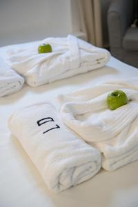 a group of towels with green apples on a table at Lisbon Dreams Estrela Suites in Lisbon