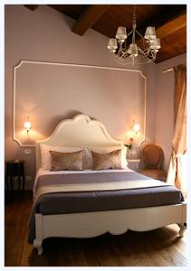 a bedroom with a large bed with a white headboard at B&B San Nicol&ograve; in Montegiorgio
