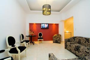 a living room with a couch and a table and chairs at Evita's Studios in Loutra Edipsou