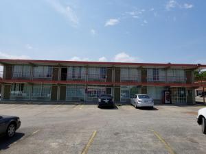 a large building with cars parked in a parking lot at Hermitage Inn in Hermitage