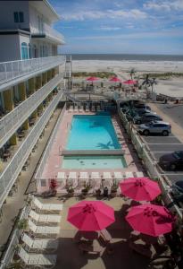 an aerial view of a hotel with a pool and pink umbrellas at Paradise Oceanfront Resort of Wildwood Crest in Wildwood Crest