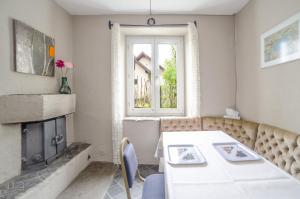 a living room with a table and a fireplace at 2,5 Zimmer Ferienwohnung mit Küche/Bad in Triesen