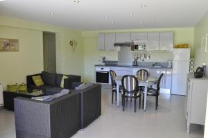 un salon avec un canapé et une table et une cuisine dans l'établissement Villa Gecko, à Saint-Raphaël