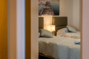 a bedroom with two beds and a picture on the wall at Cartagena Centro in Cartagena